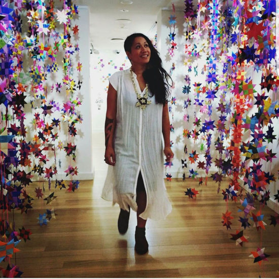 Maryann Talia Pau, standing with an installation of stars.
