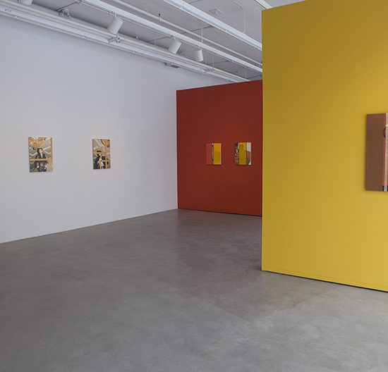 White, red and yellow painted walls, all of which have photographs hanging on them