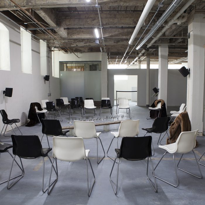 Several black and white chairs placed in a circular fashion facing the centre.