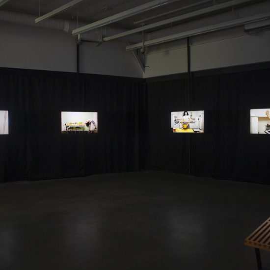 Video installation in gallery two taken from the back corner facing the entrance. Four tv's play the work in colour.